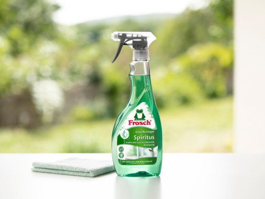 A Frosch glass cleaner bio-spirit trigger bottle stands next to a cloth