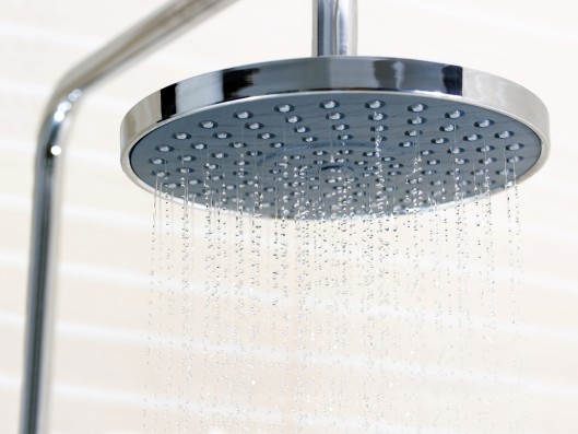 Water is running out of an flat shower head